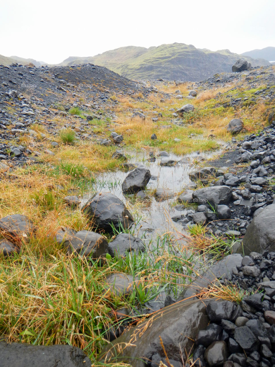 A stream flows down from the Myrdalsjokull glacier in Iceland