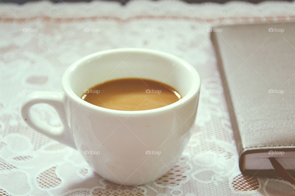 Coffee cup with diary