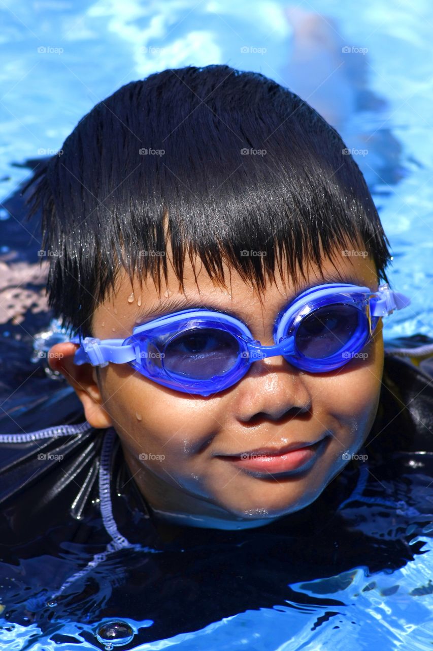 young kid in a swimming pool