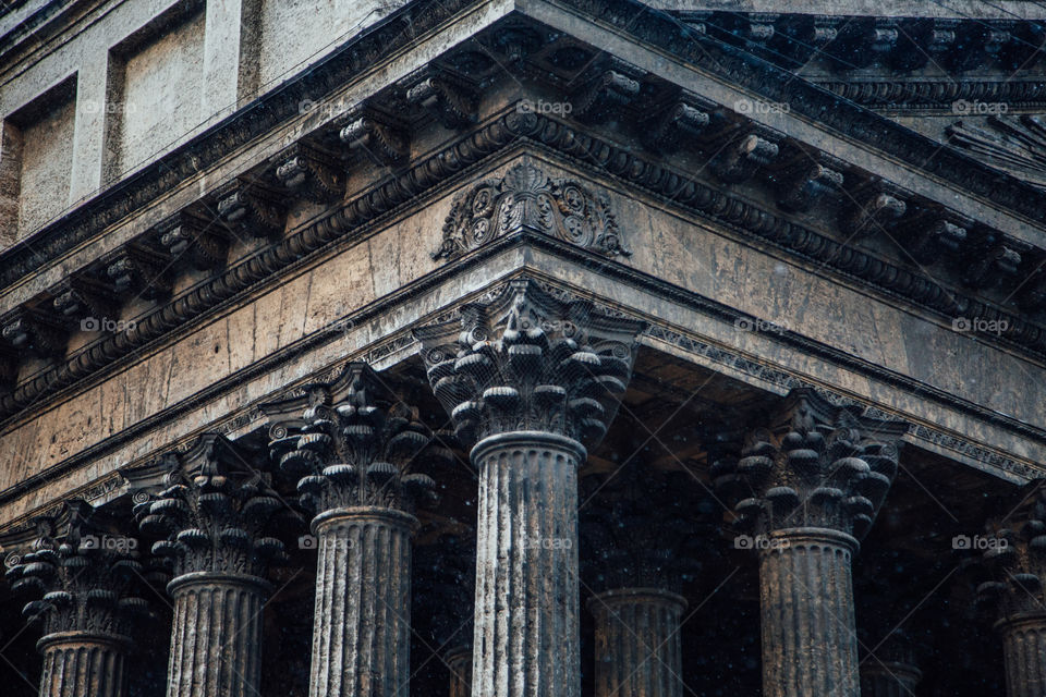 Renaissance columns of a cathedral with acanthus ornament leaves on its capitals symmetrically positioned