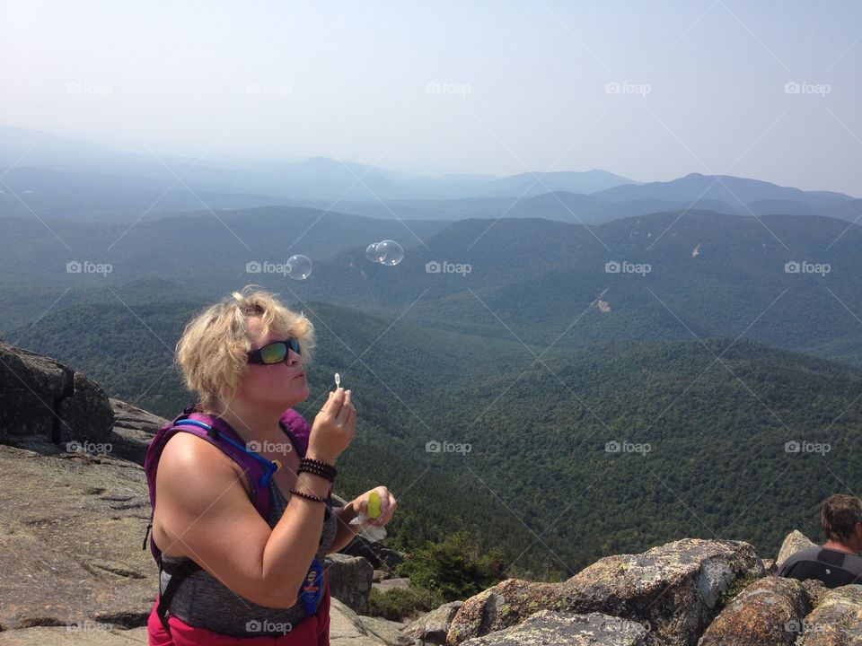 Blowing bubbles from the top of mount chocorua in the white top mountains of New Hampshire 