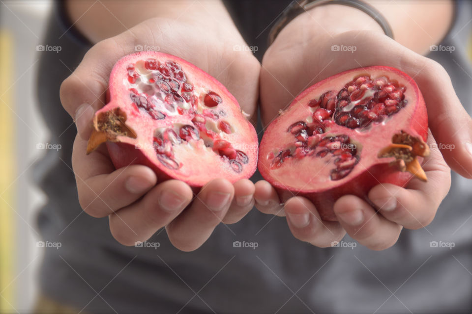 Holding pomegranate in hands