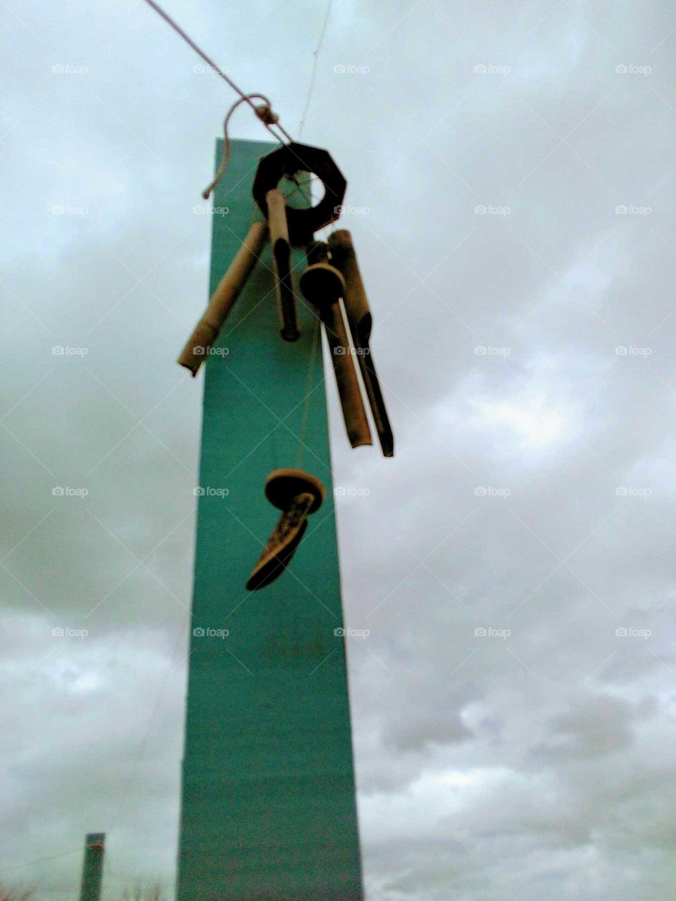 a wooden wind chime on a windy day