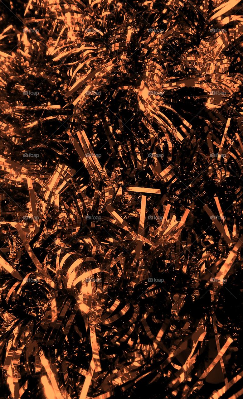 Golden shining paper strips in abundence
as brilliant texture for celebration