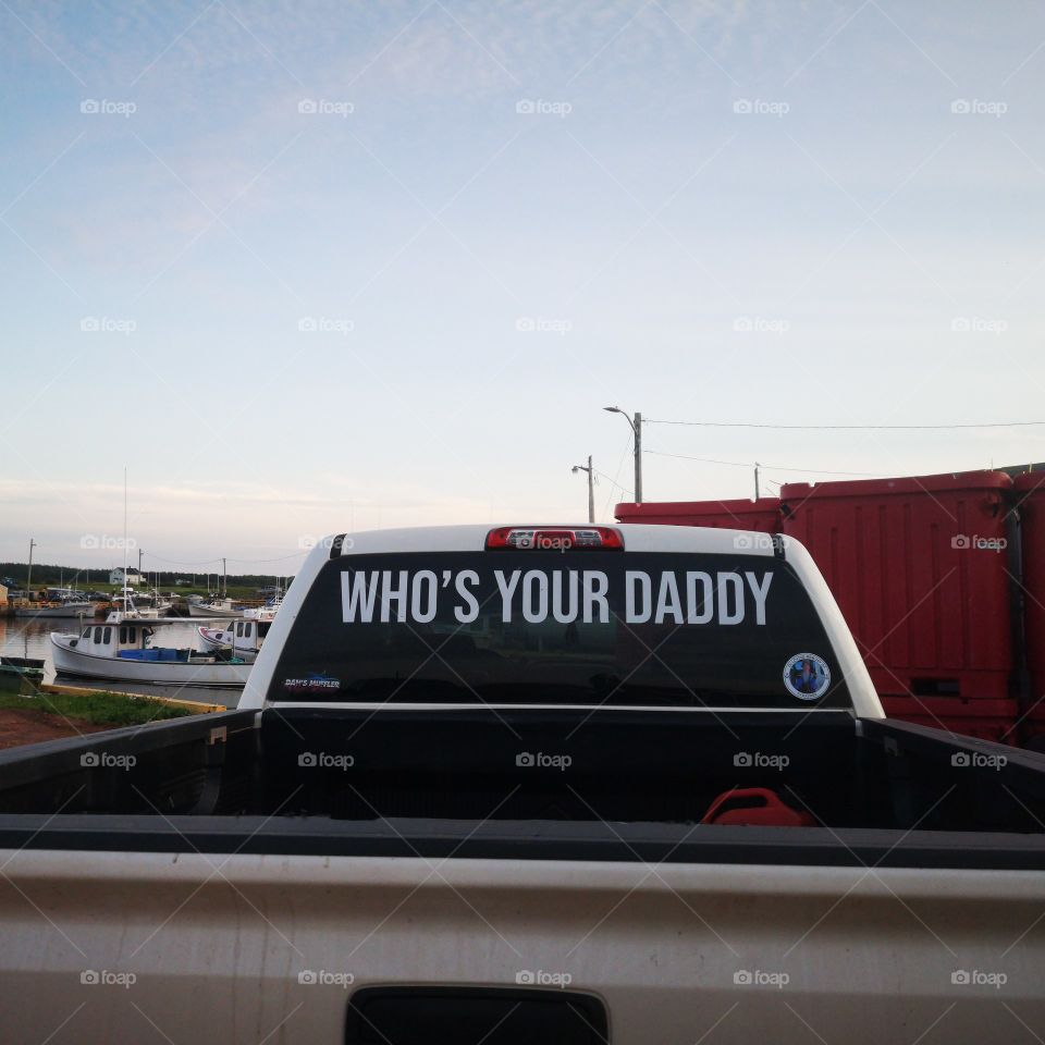 A rear window of a car in parking lot of the harbour at Skinners Pond, Prince-Edward Island, Canada