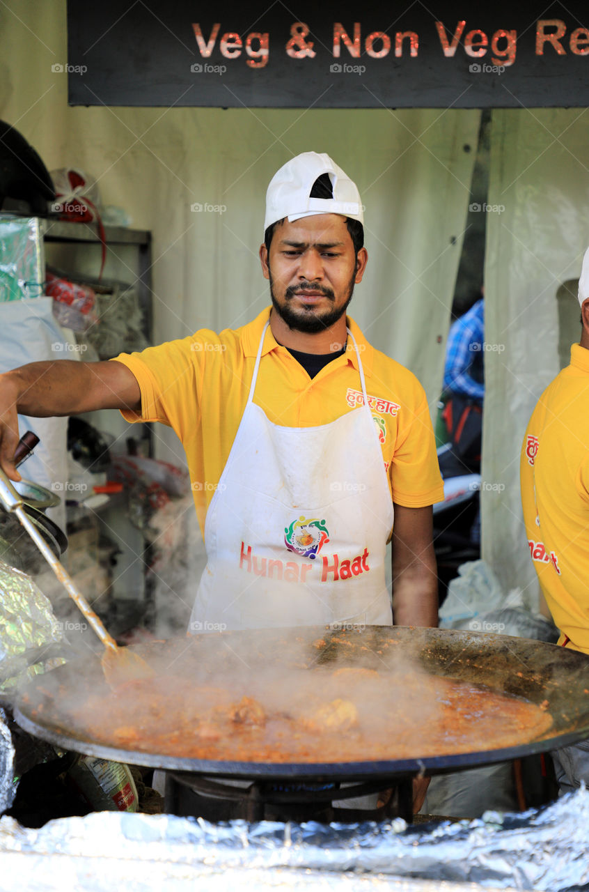 A chef cooking at the Hunar Haat, New Delhi, India