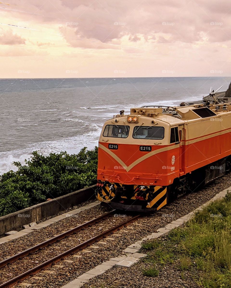 A train running by the ocean