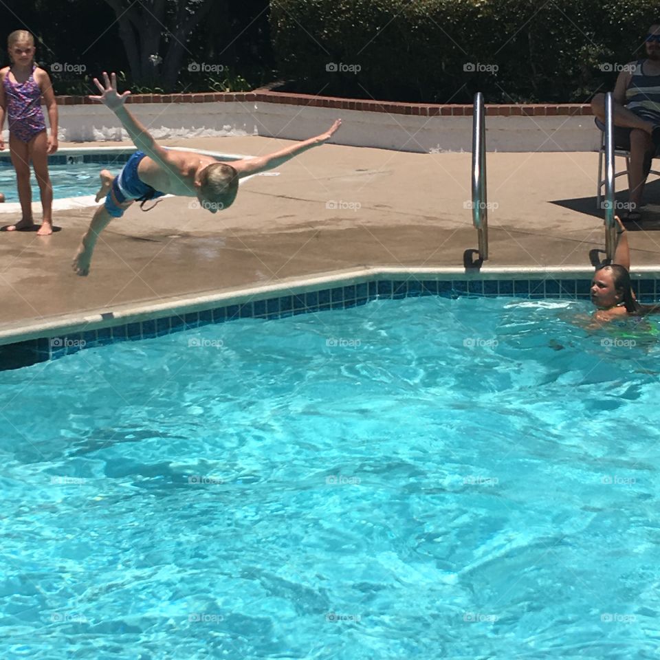 Boy diving in swimming pool