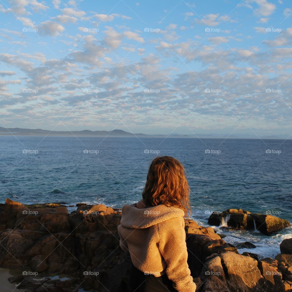 A girl overlooking the sea, Australia.