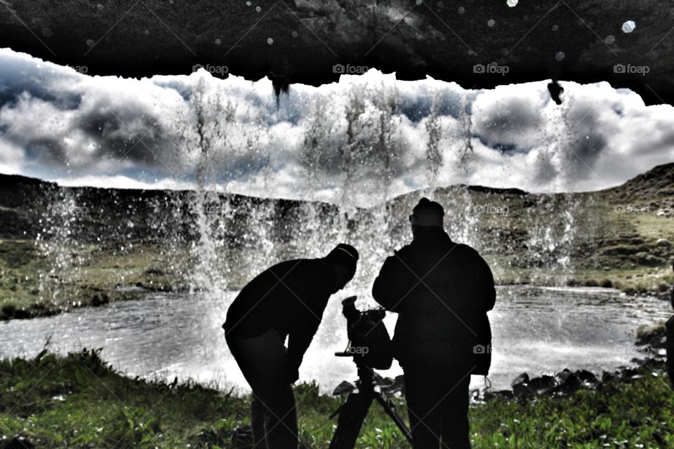 Filming from behind a waterfall in Ethiopia . Standing behind waterfall underneath overhang 