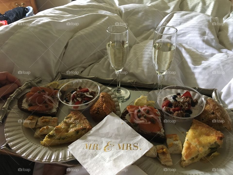 Breakfast in bed the day after our wedding. Champagne, quiche, smoked salmon and cream cheese toast and fruit and granola!