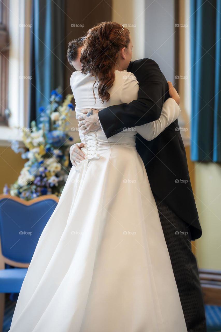 Married couple embrace after taking their wedding vows