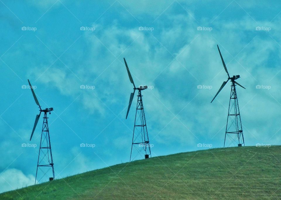 Wind Power Turbines. Wind Turbines On A Green Hill Generating Renewable Power In California
