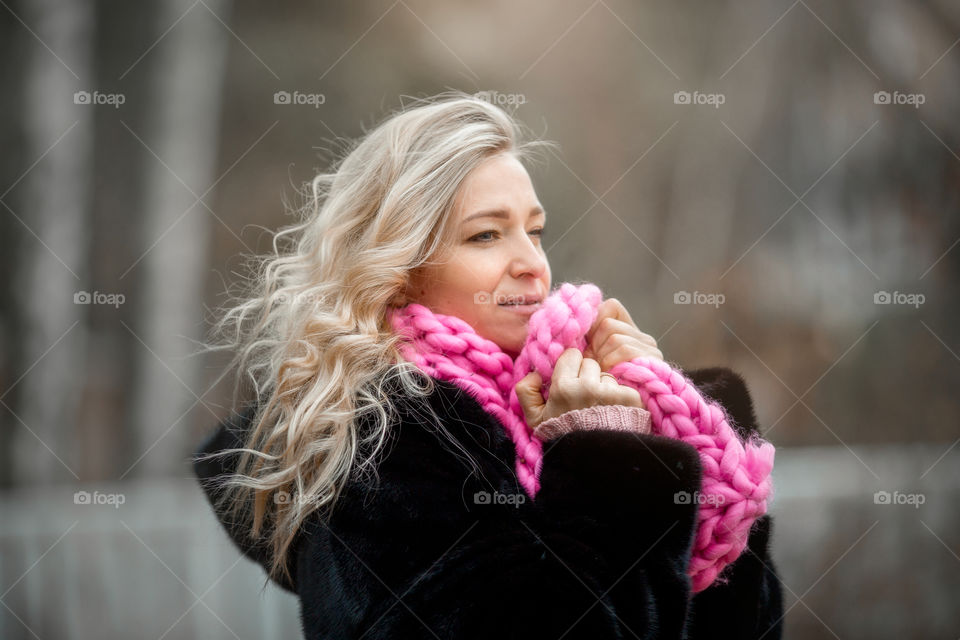 Outdoor Portrait of blonde woman in pink crochet accessories 