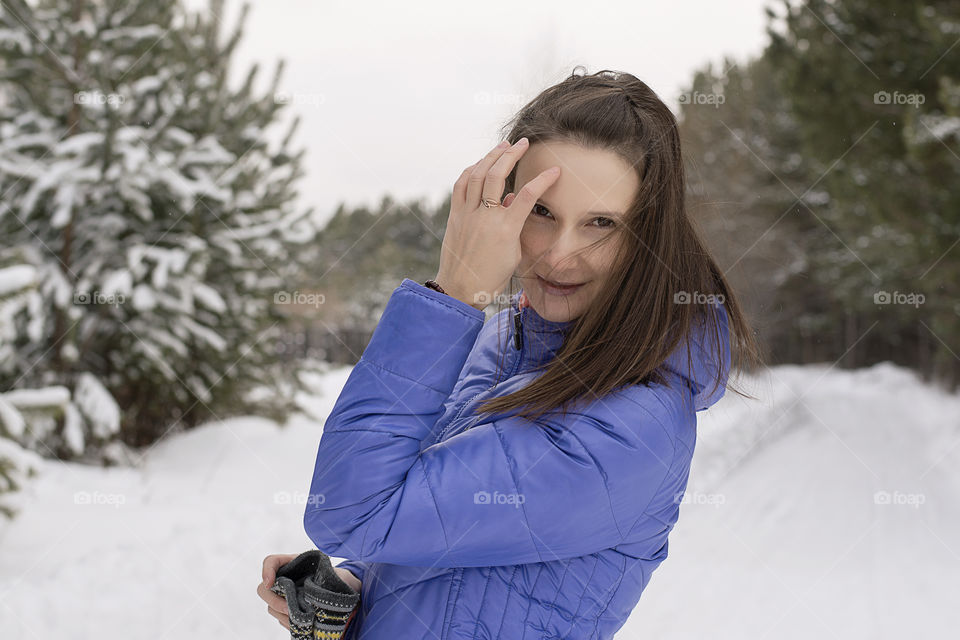 woman without a hat in the winter in the forest