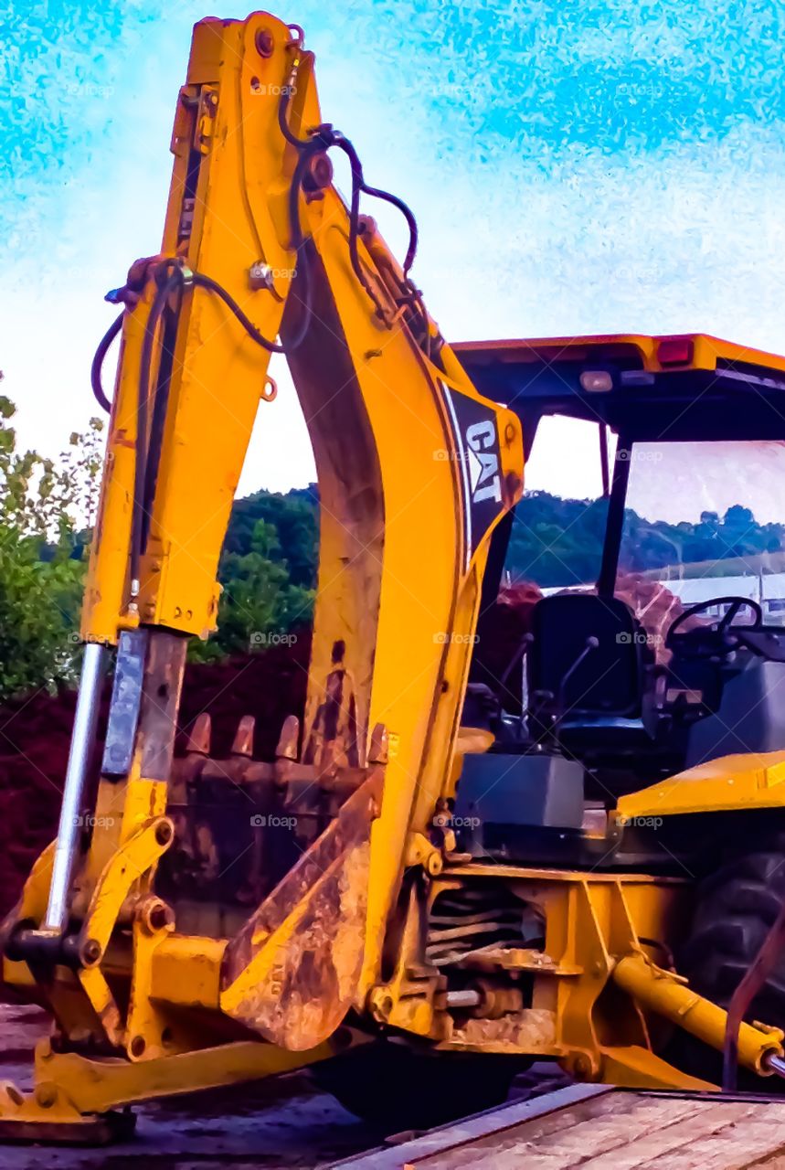 Remember the Tonka trucks from yesteryear, well this is a real life closeup of a backhoe resting from a hard day's work. 