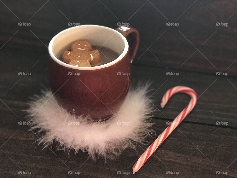 Hot cocoa with a gingerbread marshmallow and a candy cane 