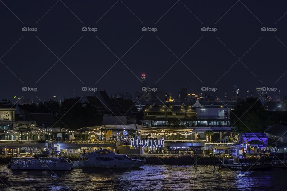 Maharaj Pier and restaurants at the Chao Phraya River at night , Bangkok in Thailand. December 13, 2018.