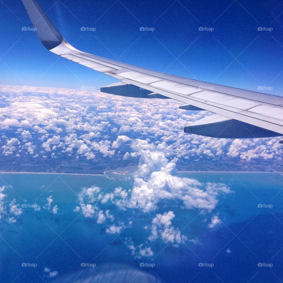 The beautiful image of the blue sky through the airplane window.