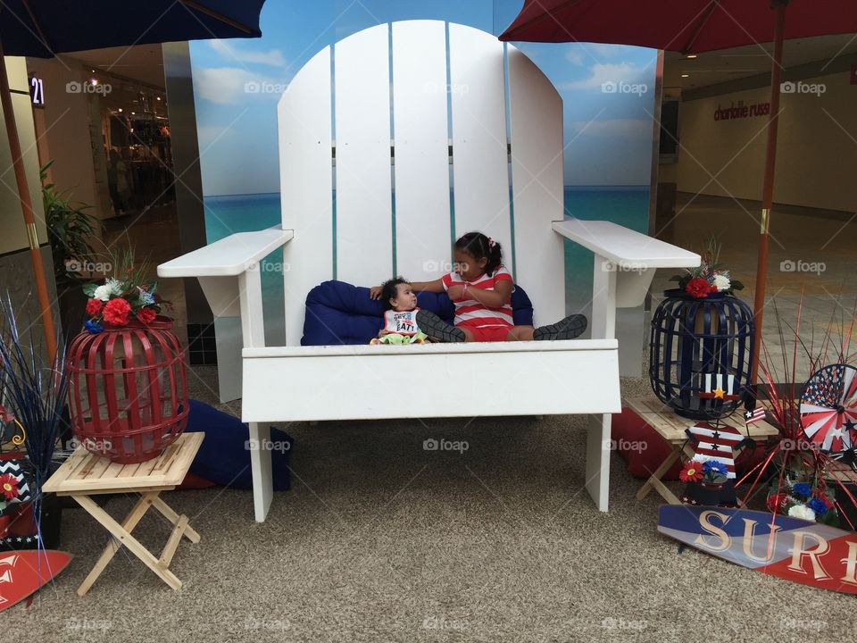 Cousin time . Having a talk with my cousin in a big summer chair at the mall 