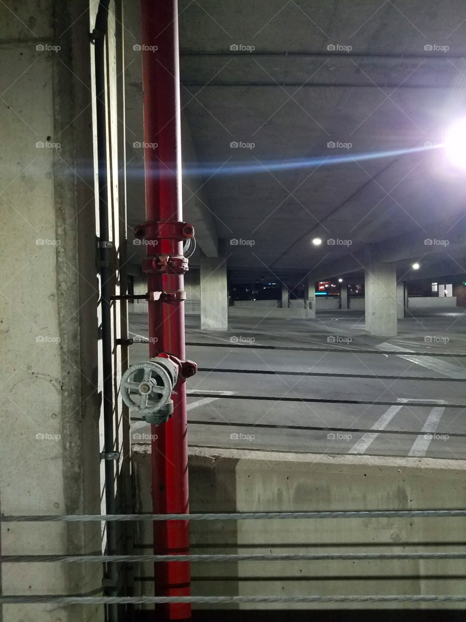 Red pipe in a parking garage