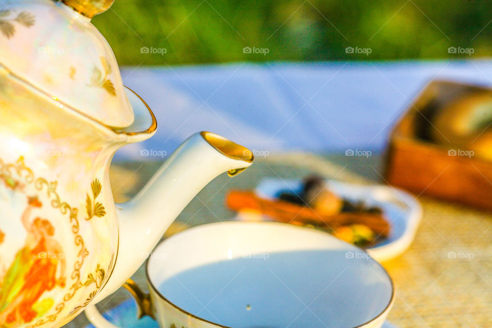 Drop of tea falling in cup