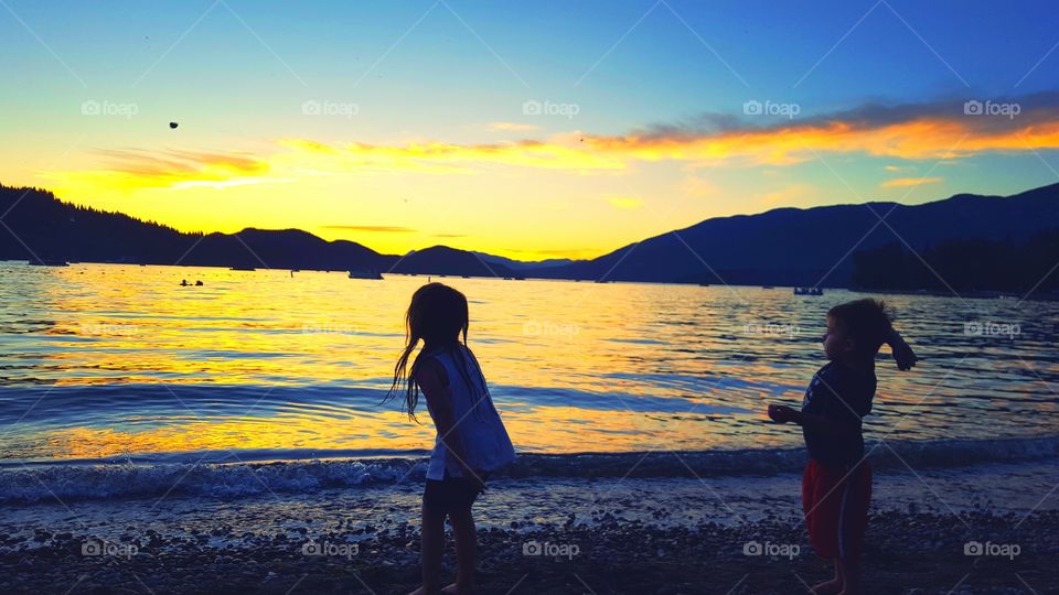 child on the beach at sunset