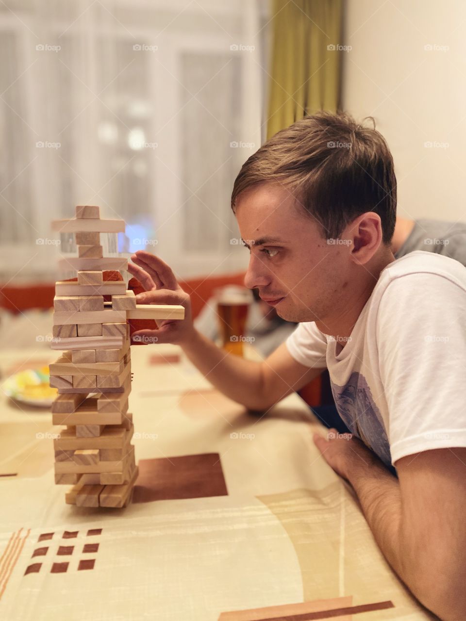 Man playing home game Jenga