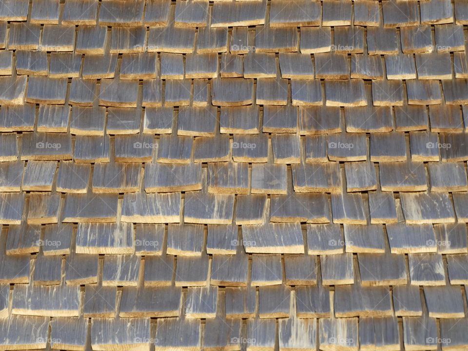 A weathered wood shingle roof