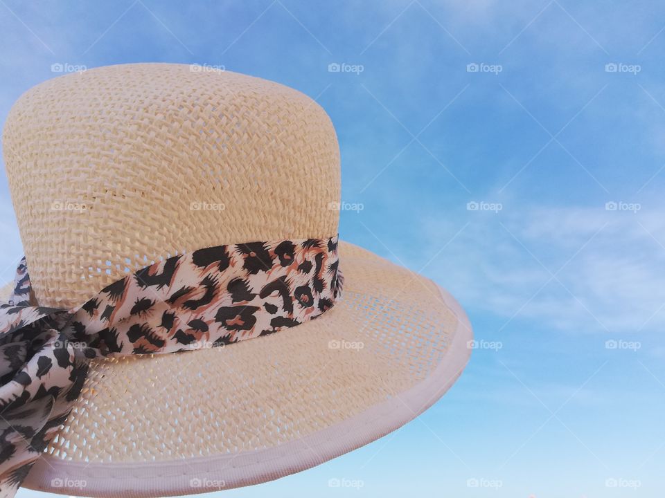 Straw hat in the foreground and the sky in the background