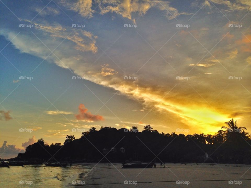 Golden Light in the Sky. It is a golden light streaming down to the sky at Lipe island (Thailand).