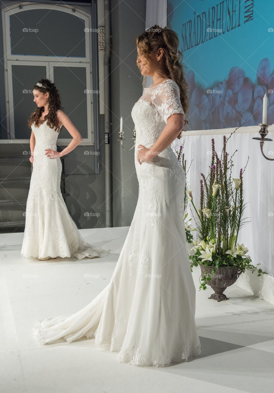 Fashion show at a wedding fair. Here are the latest dresses and clothes for both bride and groom