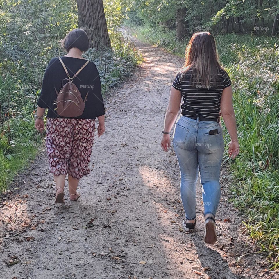 sisters walk in woods