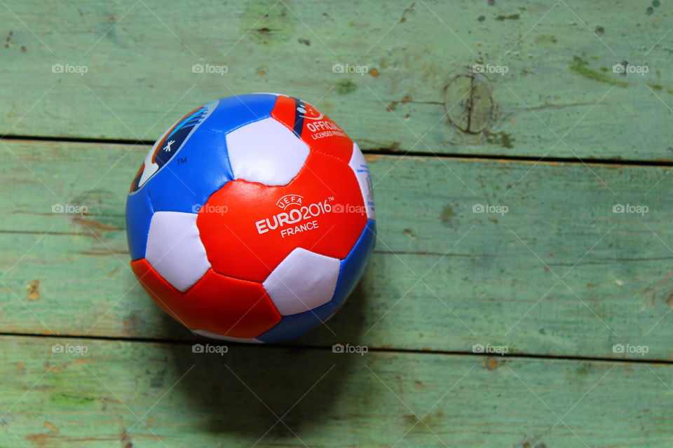 miniature soccer ball from euro 2016 on a wooden table