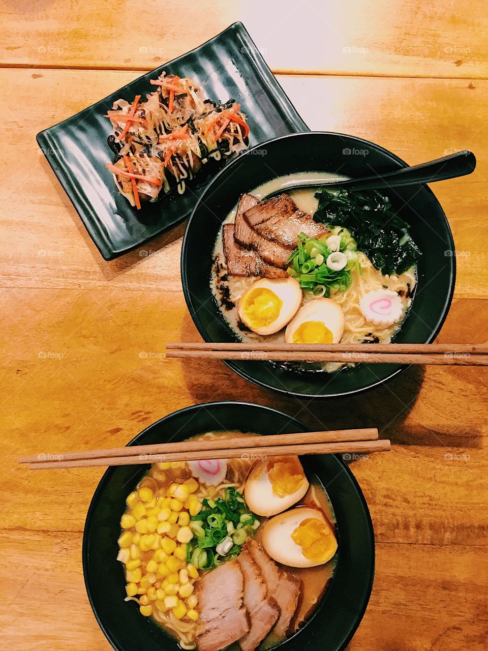Two big bowls of delicious ramen with a side order of takoyaki.