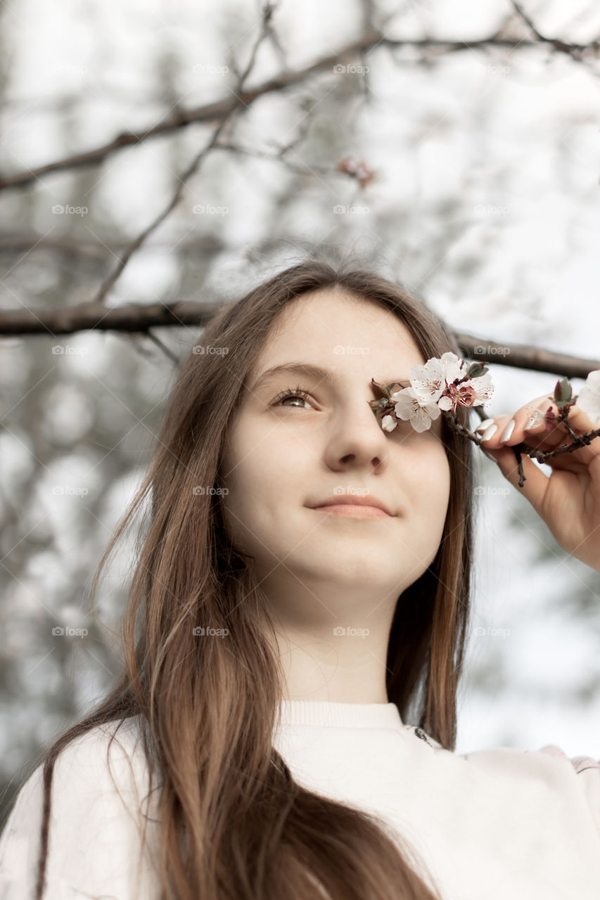 Portrait of teenage girl with flowers.
