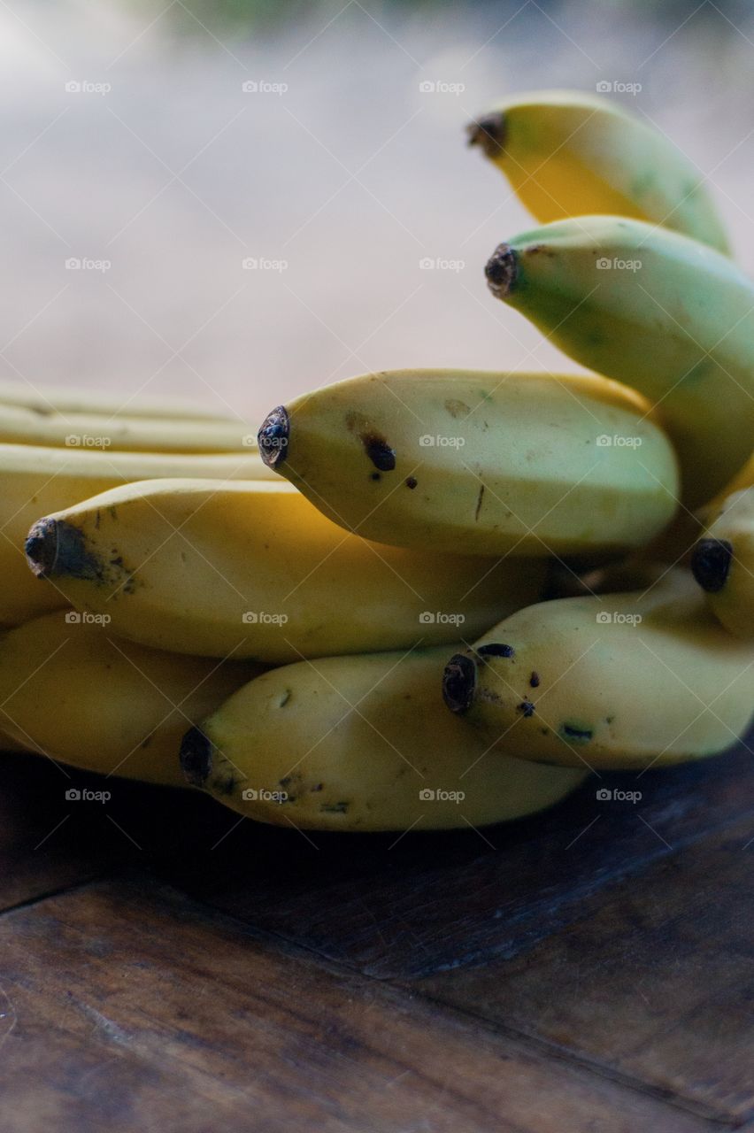 Yellow banana on a wooden table