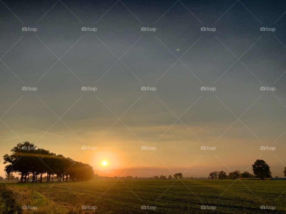 Beautiful idyllic Countryside sunrise landscape taken during the Golden hour in the summer