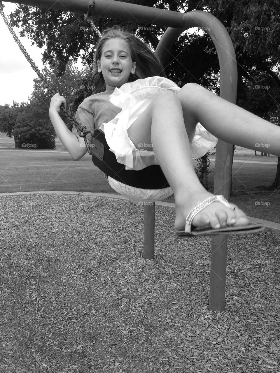 Swing high. Girl swinging at the park