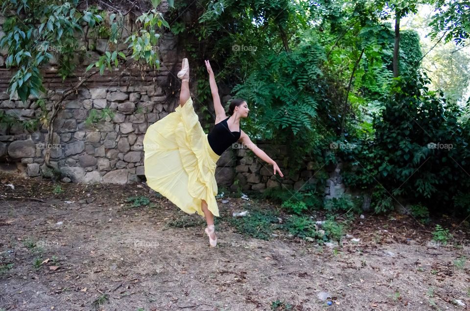 Young Female Ballerina Dancing Outside in Nature