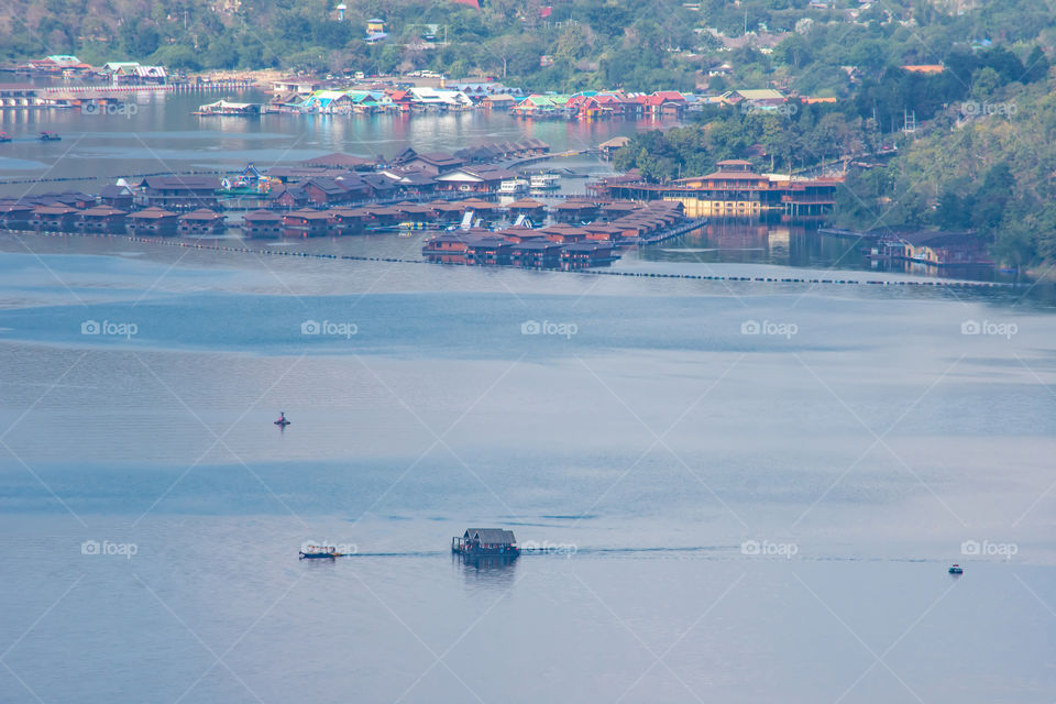 The ships were dragging a houseboat in the dam at Sri Nakarin dam , Kanchana buri in Thailand.