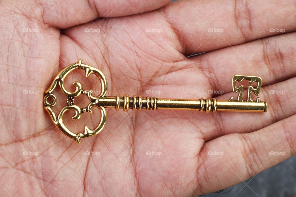 Home owners golden key in a hand