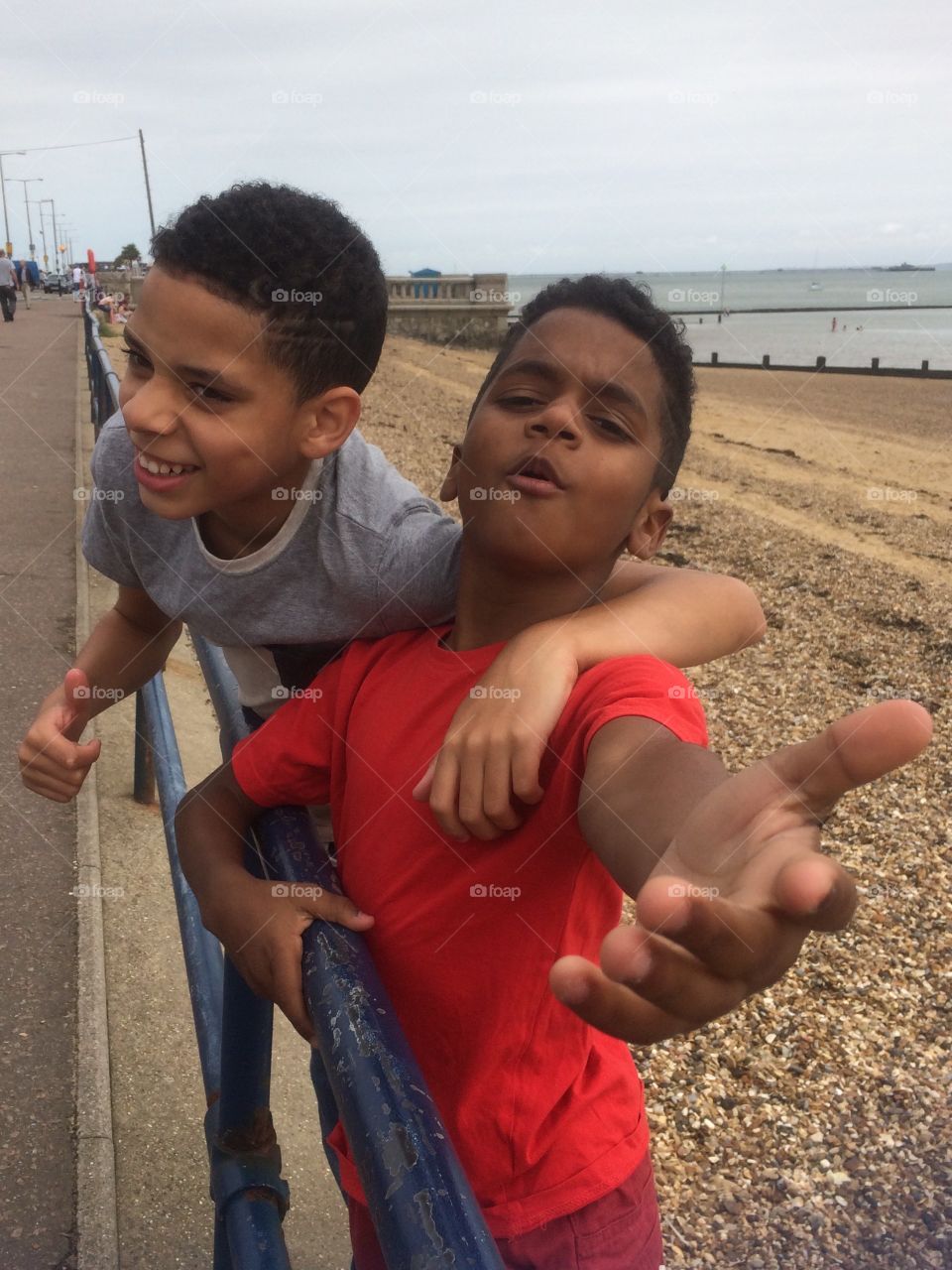 Two boys at railings holiday vacation at Southend