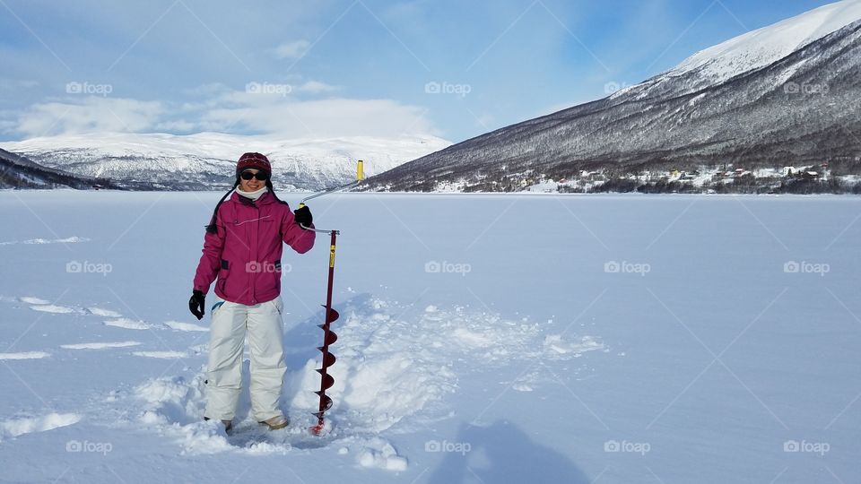 Drilling ice for fishing