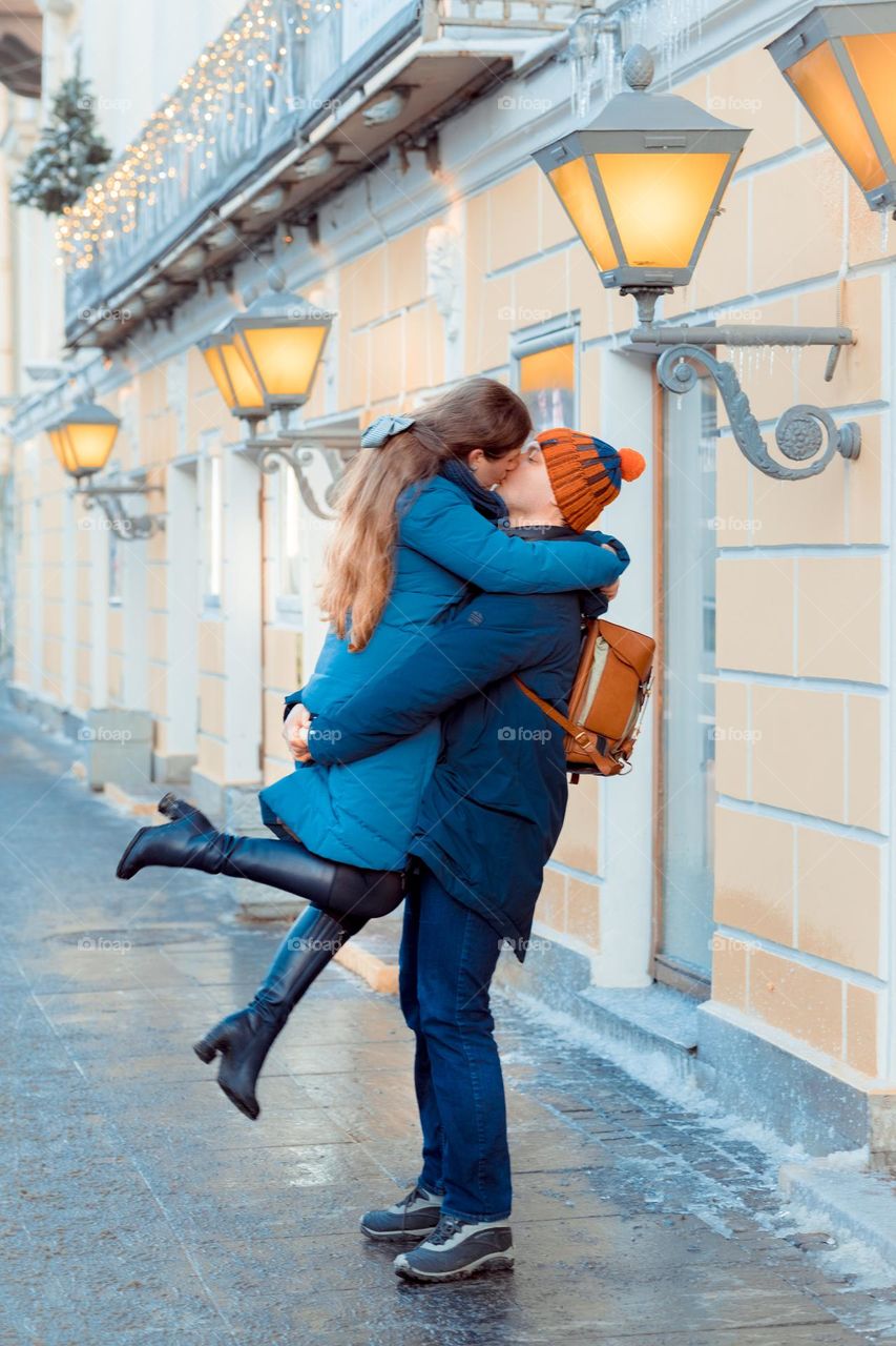 Loving couple kissing under lanterns