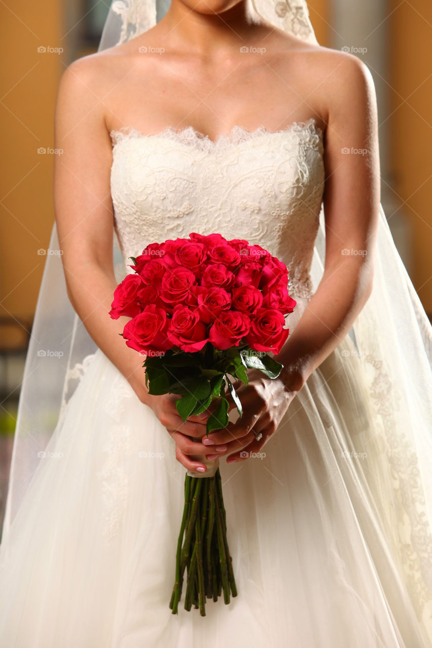 Red roses flower bouquet and bride