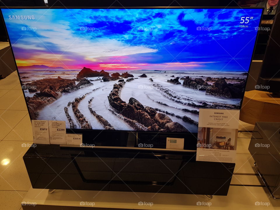 Samsung 55" QLED ambient mode television 4K Ultra High Definition television on black TV stand at Peter Jones department store Sloane square Chelsea Kings road London