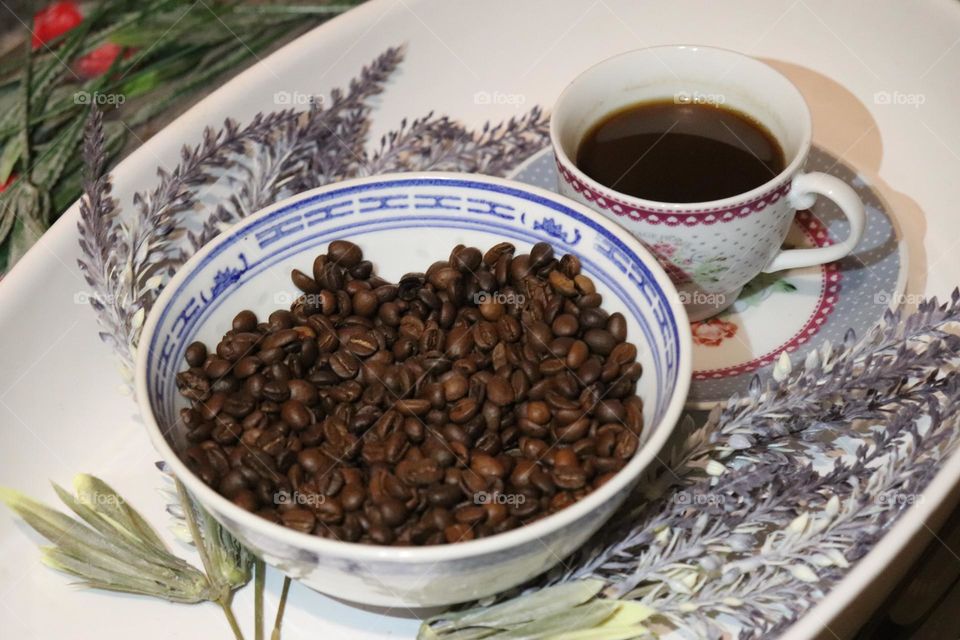 A cup of coffee and coffee beans