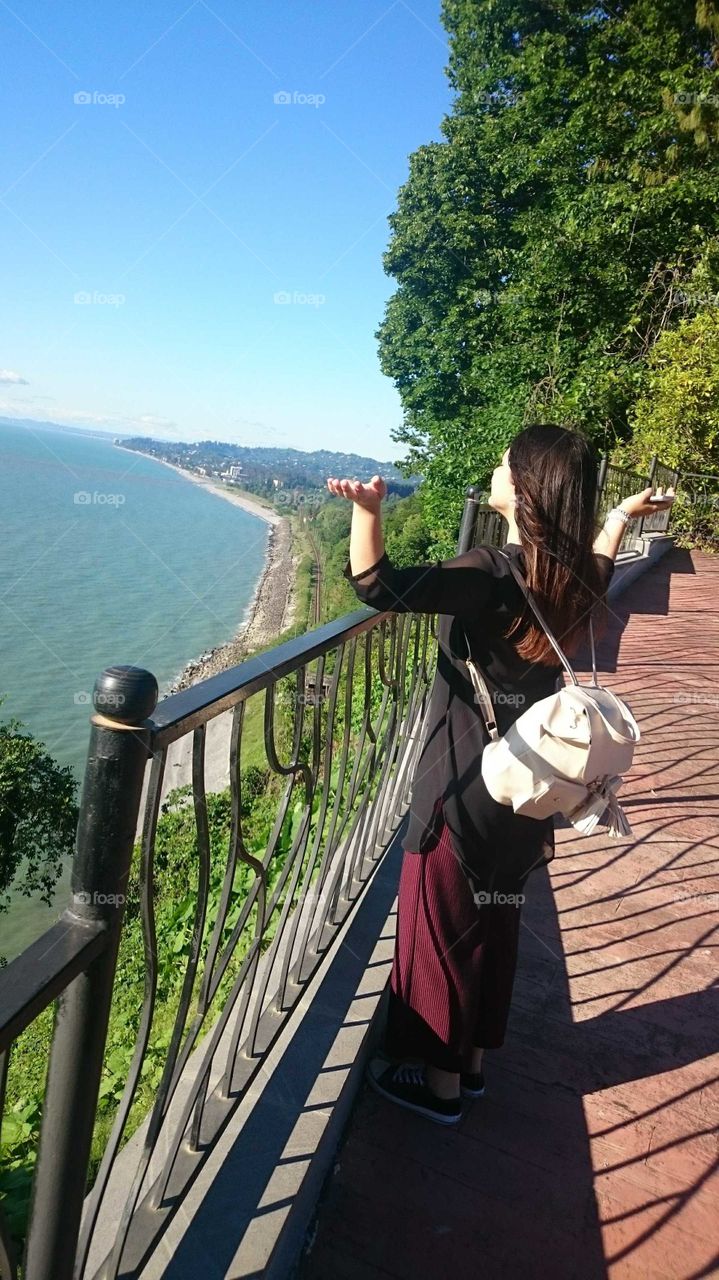 The girl looks at the expanses of the Black Sea