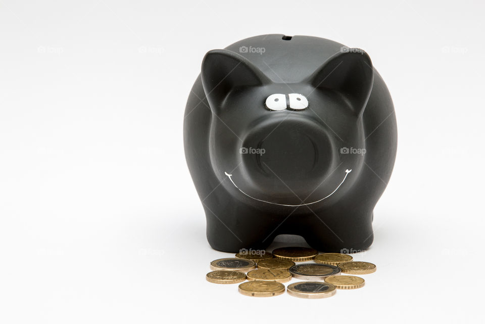 Black Piggy Bank With Coins, Isolated In White Backgound
